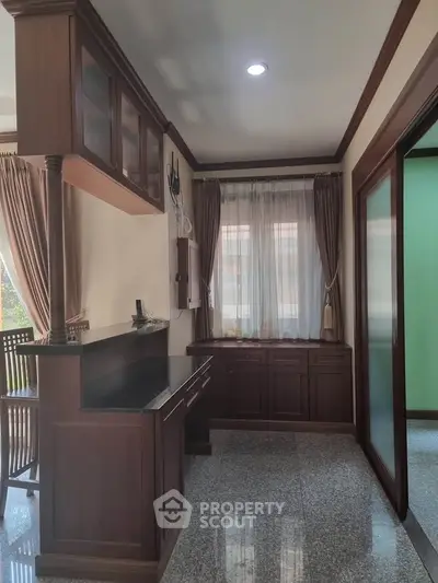 Elegant study room with wooden cabinetry and natural light