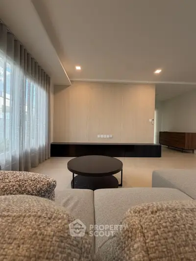 Spacious modern living room with elegant decor and large windows