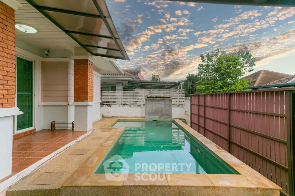 Charming backyard with private pool and stylish patio in suburban home.