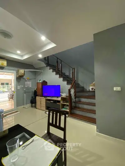 Modern living room with sleek staircase and open layout