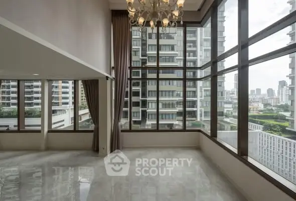Spacious corner unit with floor-to-ceiling windows offering stunning city views in a modern high-rise building.
