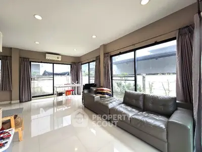Spacious living room with modern furniture and large windows for natural light