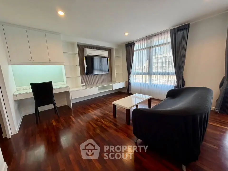 Spacious living room with elegant hardwood floors and modern furnishings