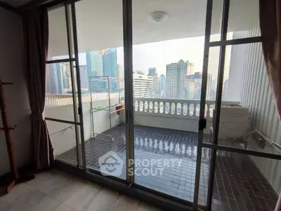 Spacious balcony with city view in modern high-rise apartment
