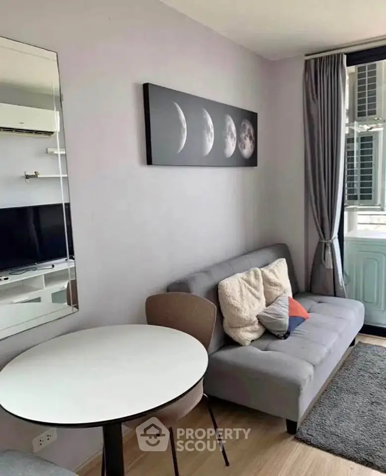 Modern living room with stylish decor and cozy seating in a bright apartment.