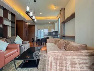 Spacious modern living room with elegant lighting and cozy seating in a stylish apartment.