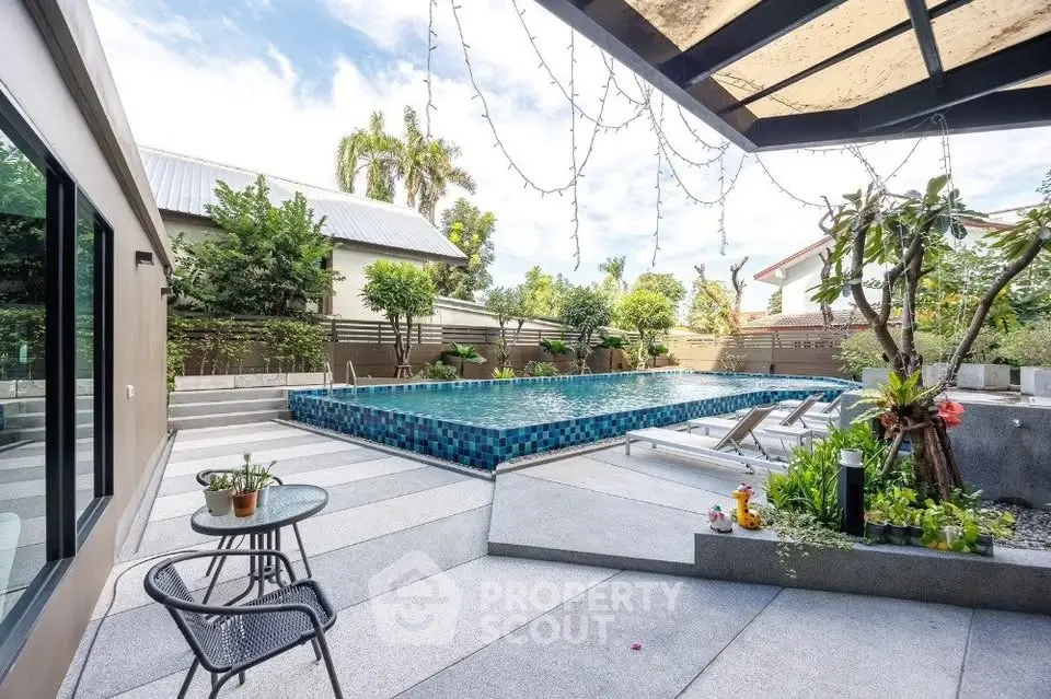 Luxurious modern backyard with stunning pool and lush greenery