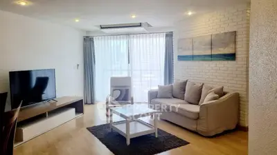 Spacious modern living room with large TV and cozy seating area