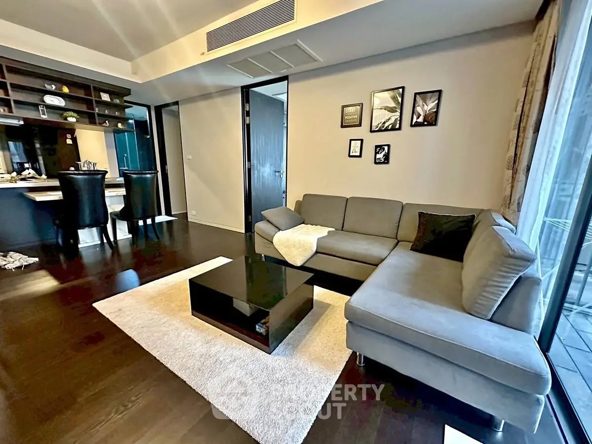 Modern living room with sleek furniture and open kitchen layout