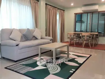 Spacious living room with modern decor and large windows for natural light.