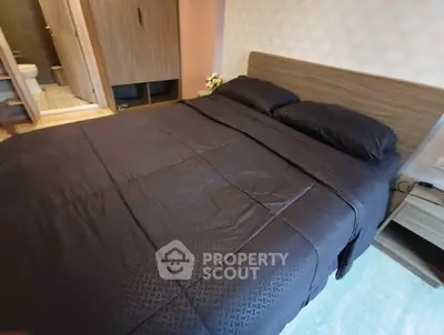 Cozy bedroom with modern decor and ensuite bathroom in a stylish apartment.