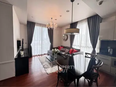 Elegant living room with modern decor, large windows, and stylish furniture.