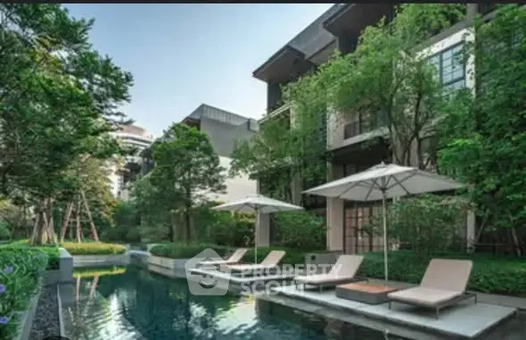 Luxurious residential building with serene pool and lush greenery