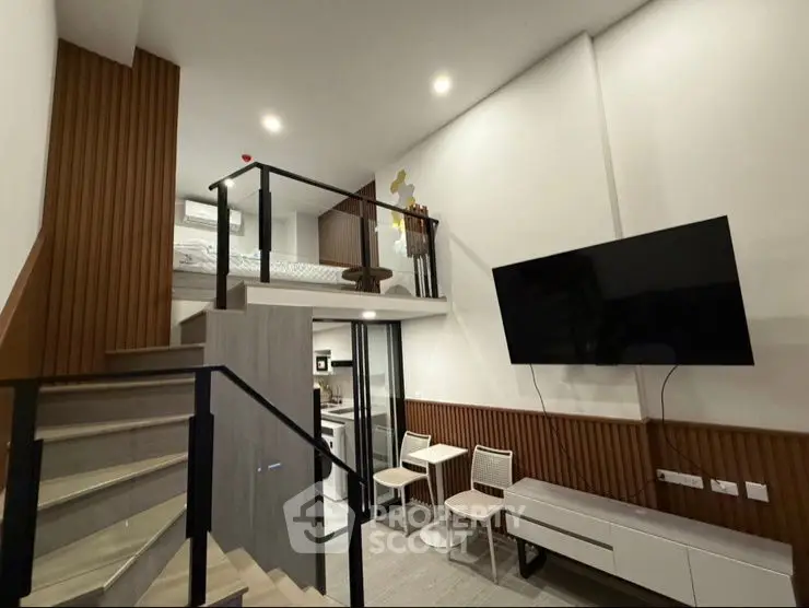 Modern loft-style living room with mezzanine and sleek decor