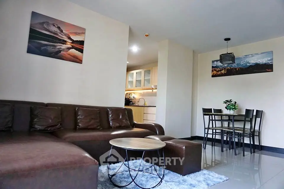 Spacious living room with modern decor and open kitchen layout