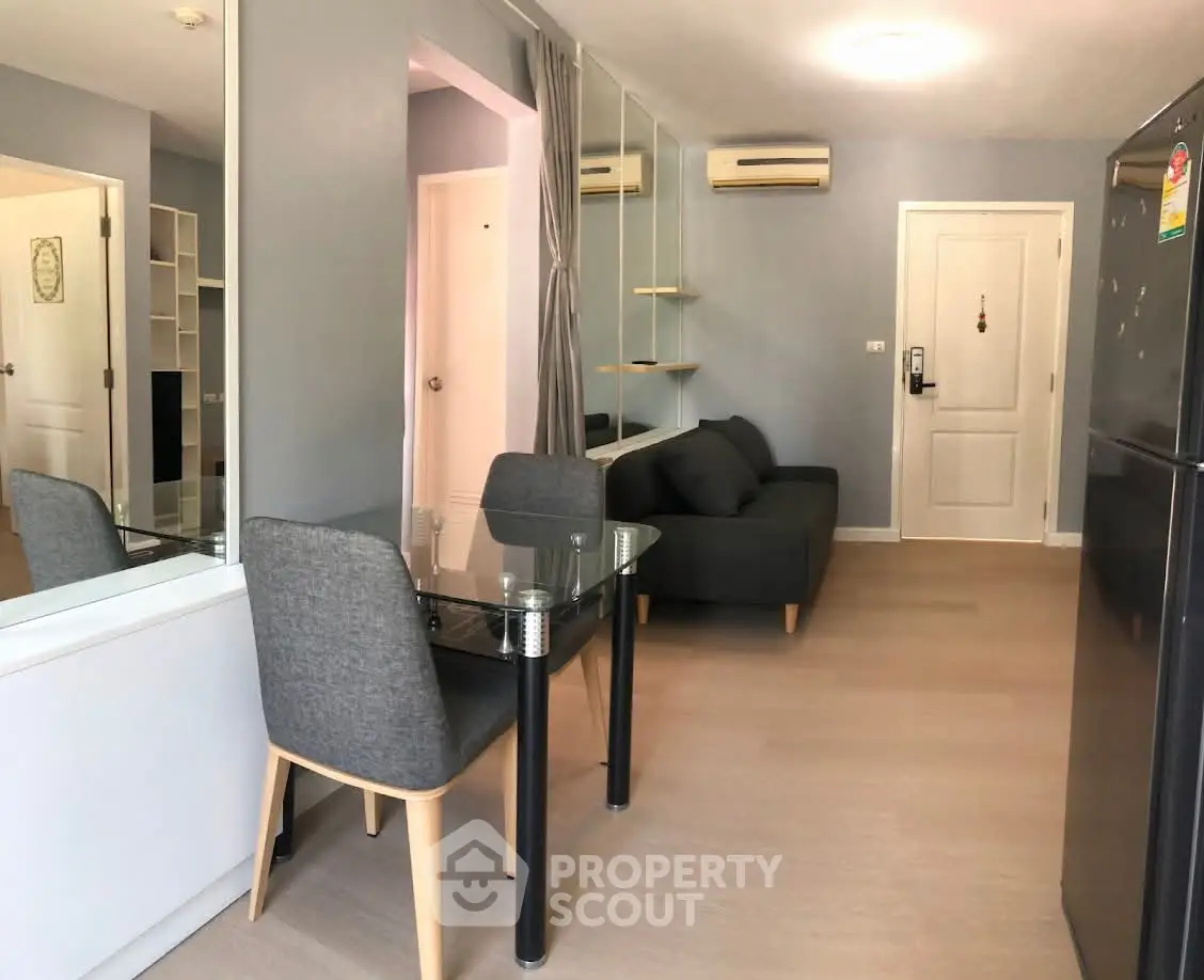 Modern living room with sleek furniture and air conditioning in a stylish apartment.