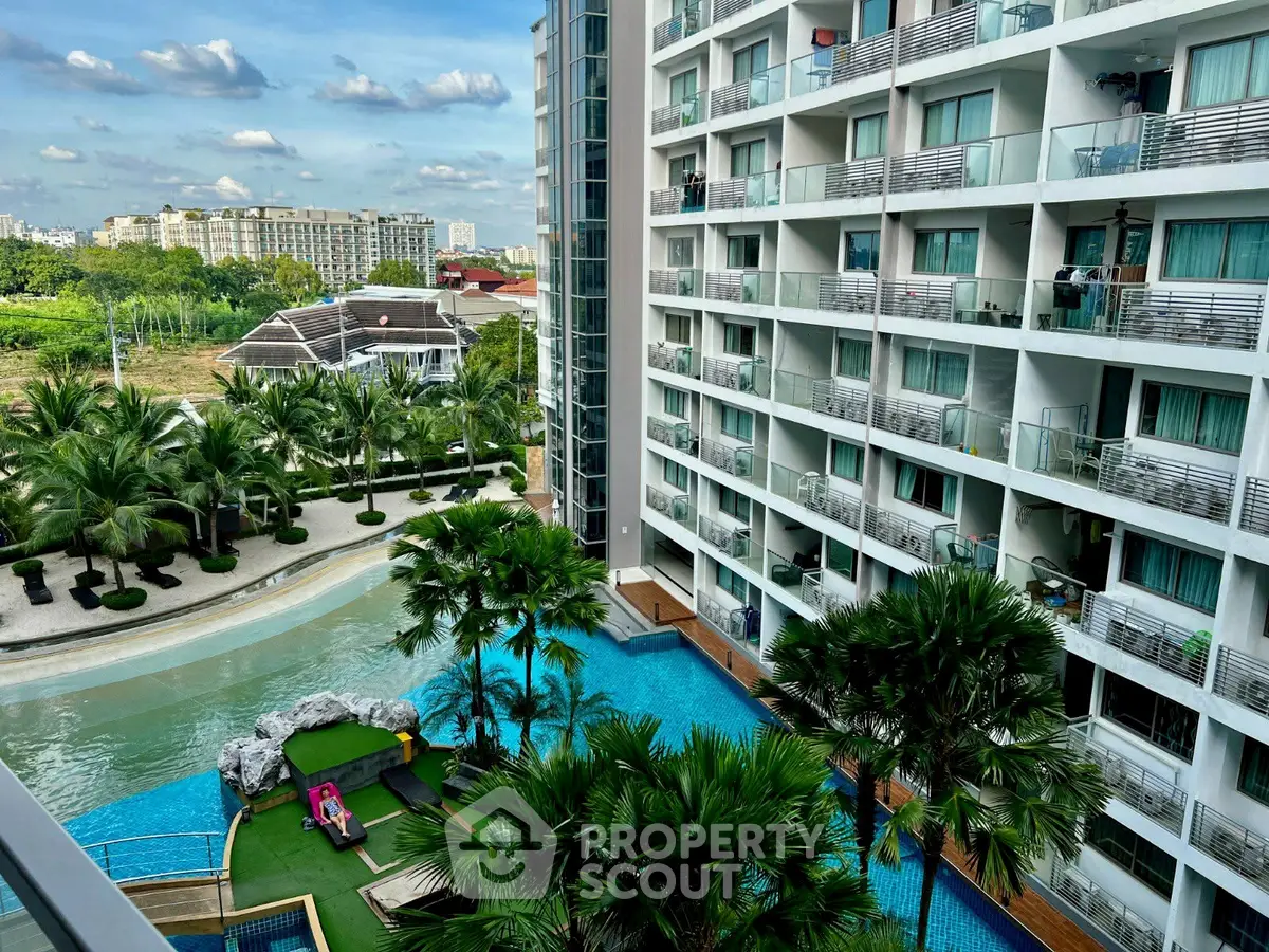 Luxurious apartment complex with stunning pool and lush greenery view.