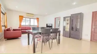 Spacious living room with modern furniture and large windows for natural light.