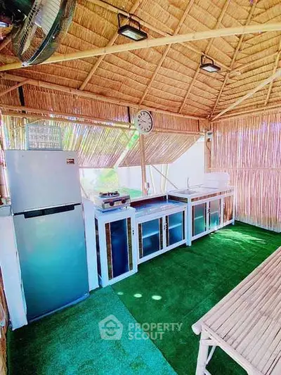 Charming outdoor kitchen with bamboo decor and modern appliances