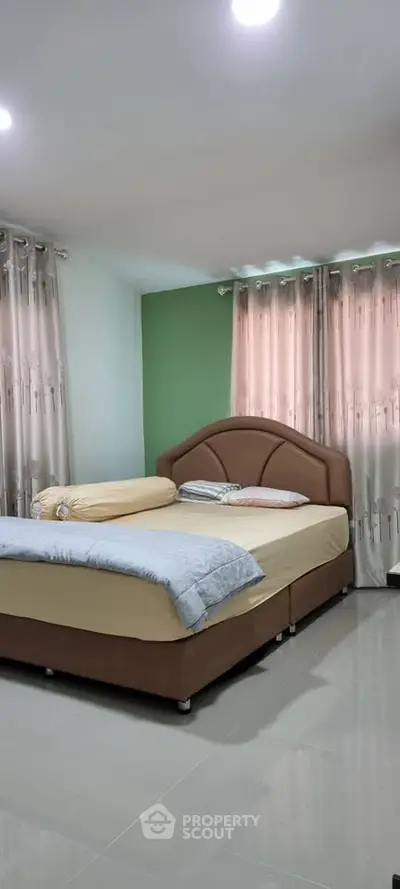 Cozy bedroom with elegant curtains and comfortable bed in modern home