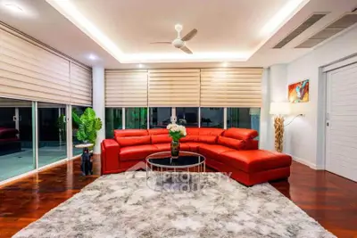 Luxurious modern living room with red sectional sofa and plush rug