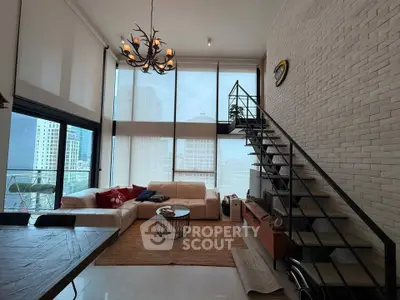 Modern living room with high ceilings, large windows, and stylish staircase in urban apartment.