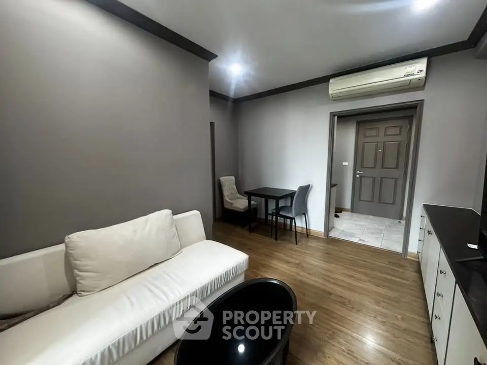 Modern living room with sleek furniture and air conditioning in a stylish apartment.