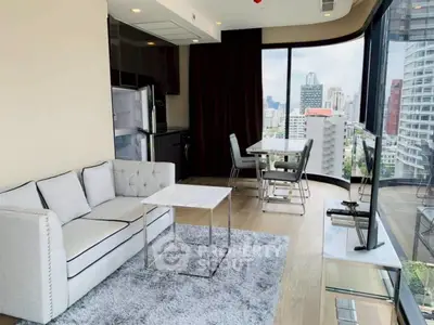 Modern living room with city view, elegant furniture, and large windows.