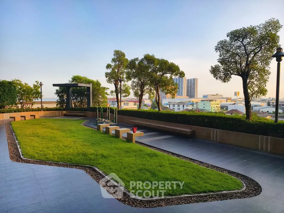 Spacious rooftop garden with lush greenery and city views, ideal for relaxation and leisure activities.