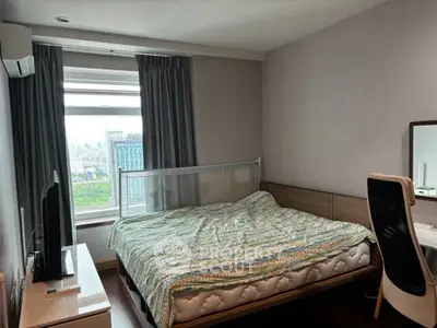 Modern bedroom with city view, featuring cozy bed and stylish furniture.
