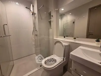 Modern bathroom with glass shower and sleek fixtures