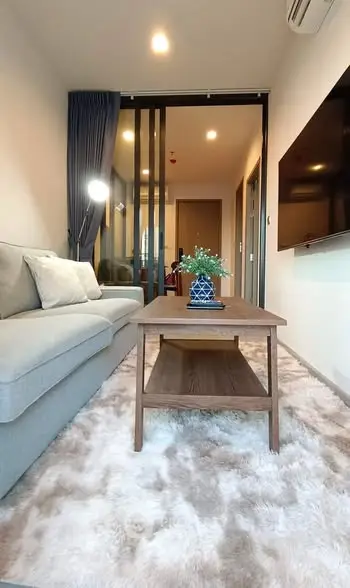 Modern living room with cozy sofa, stylish coffee table, and elegant decor in a chic apartment.
