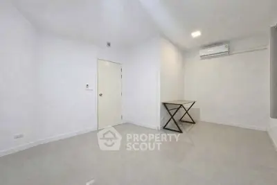 Minimalist empty room with air conditioning and sleek tile flooring