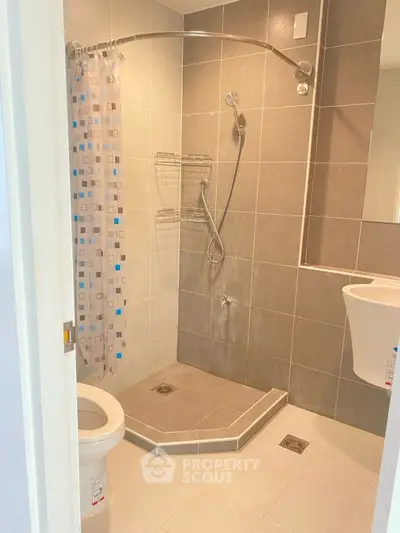 Modern bathroom with tiled shower and sleek fixtures