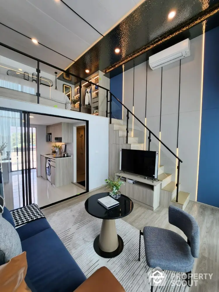 Modern loft-style living room with mezzanine, sleek furniture, and open kitchen layout.