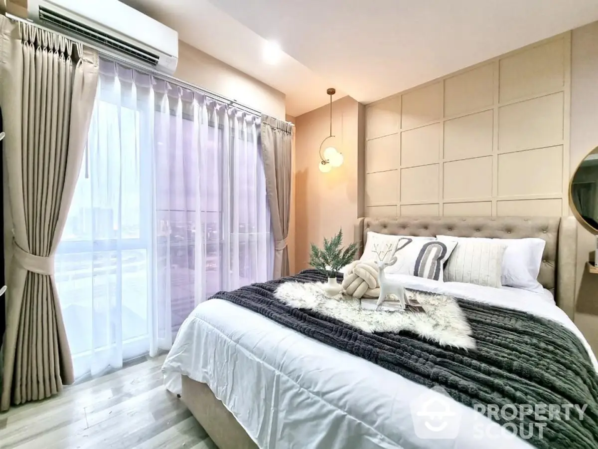 Luxurious bedroom with elegant decor and large window offering natural light.