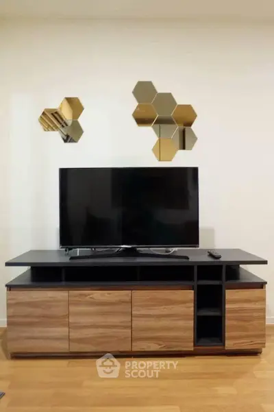 Modern living room with stylish TV stand and geometric wall decor