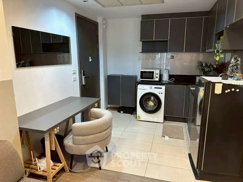 Modern kitchen with sleek cabinets and integrated washing machine
