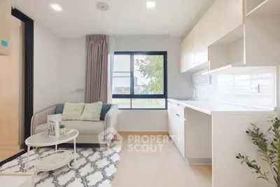 Modern living room with cozy sofa and stylish kitchen in open layout