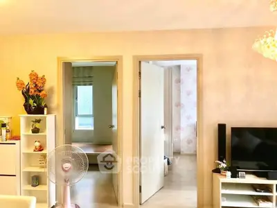Bright living area with modern decor and open doorway views
