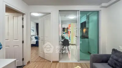 Modern apartment interior with sliding glass doors, cozy living area, and stylish dining space.