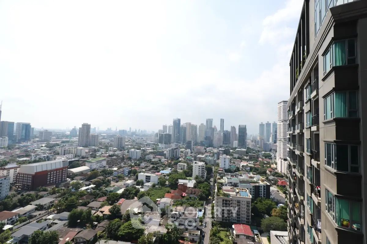 Stunning cityscape view from high-rise building balcony, showcasing urban skyline and vibrant neighborhood.