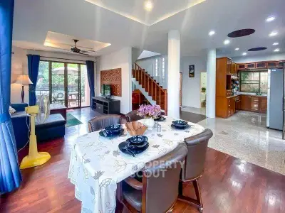 Spacious open-plan living and dining area with modern kitchen and elegant decor.