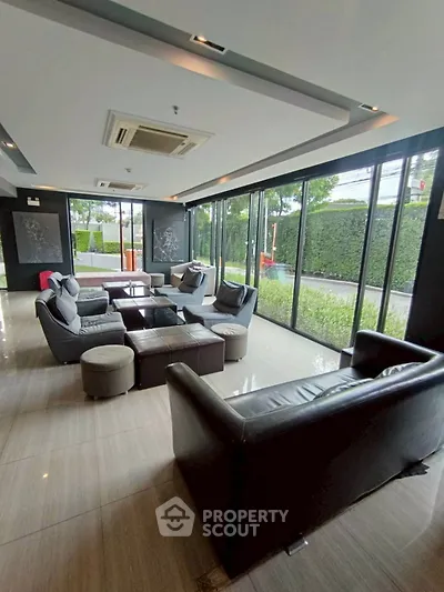 Spacious modern living room with large windows and stylish furniture
