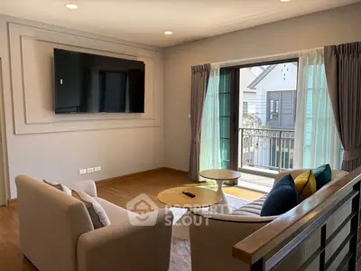 Modern living room with stylish furniture and balcony view in a contemporary home.