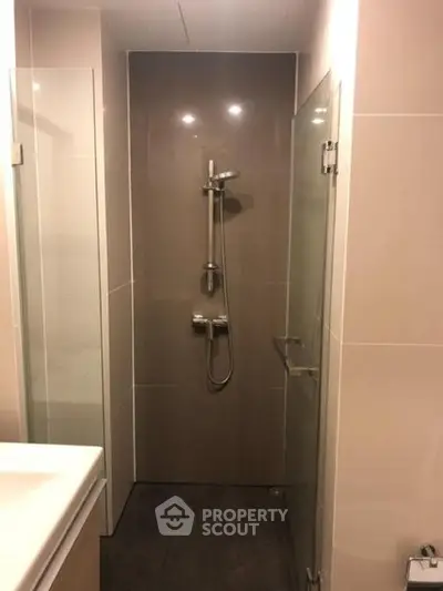 Modern bathroom with sleek shower design and glass door enclosure.