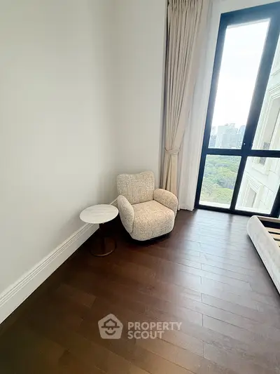 Cozy corner with plush armchair and scenic window view in modern apartment