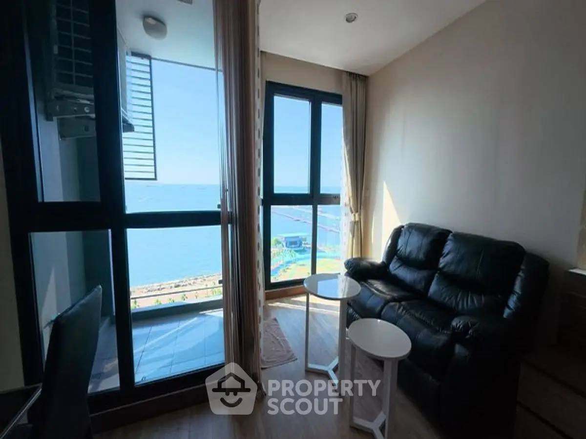 Stunning ocean view from modern living room with balcony access