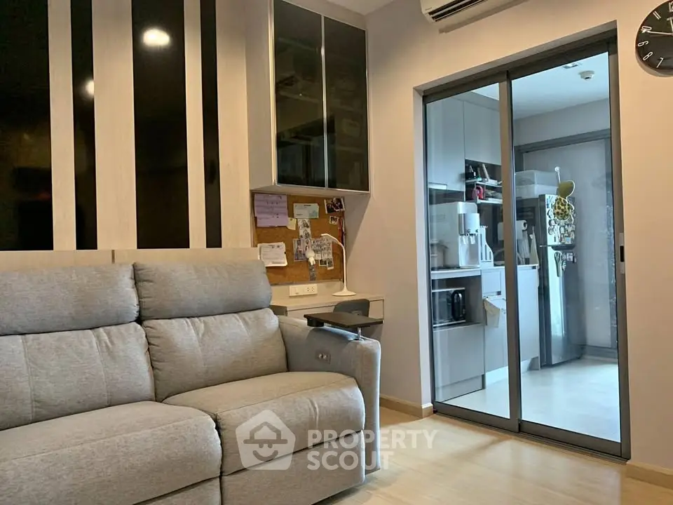 Modern living room with cozy sofa and sleek kitchen view