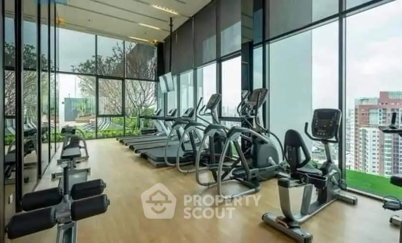 Modern gym with panoramic city views and state-of-the-art fitness equipment.